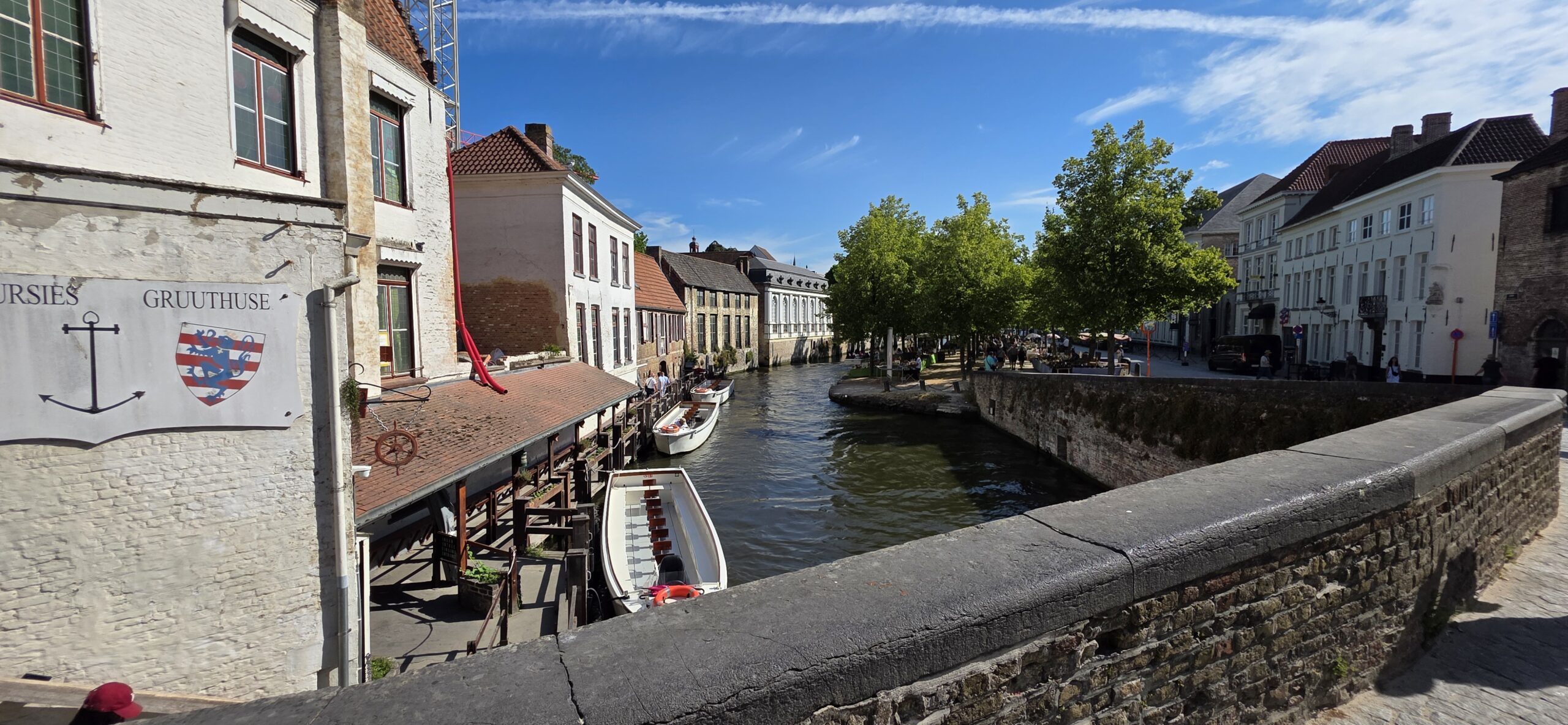 Canal lined with stepped-gable houses and moored boats in central Bruges