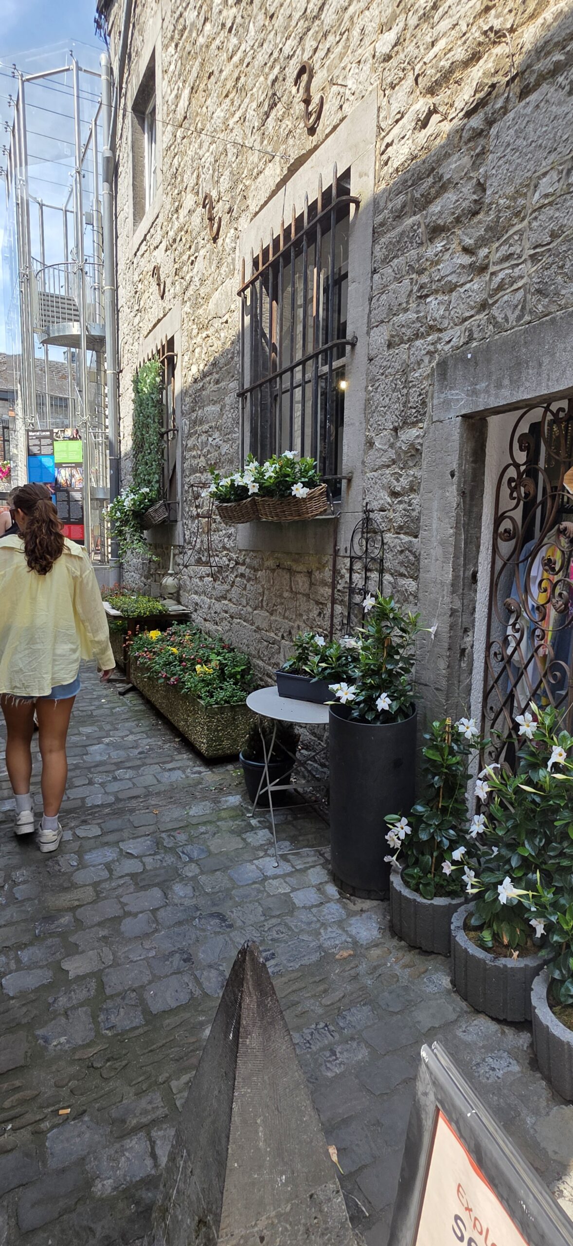 Narrow cobbled street lined with flower boxes in the old town of Durbuy