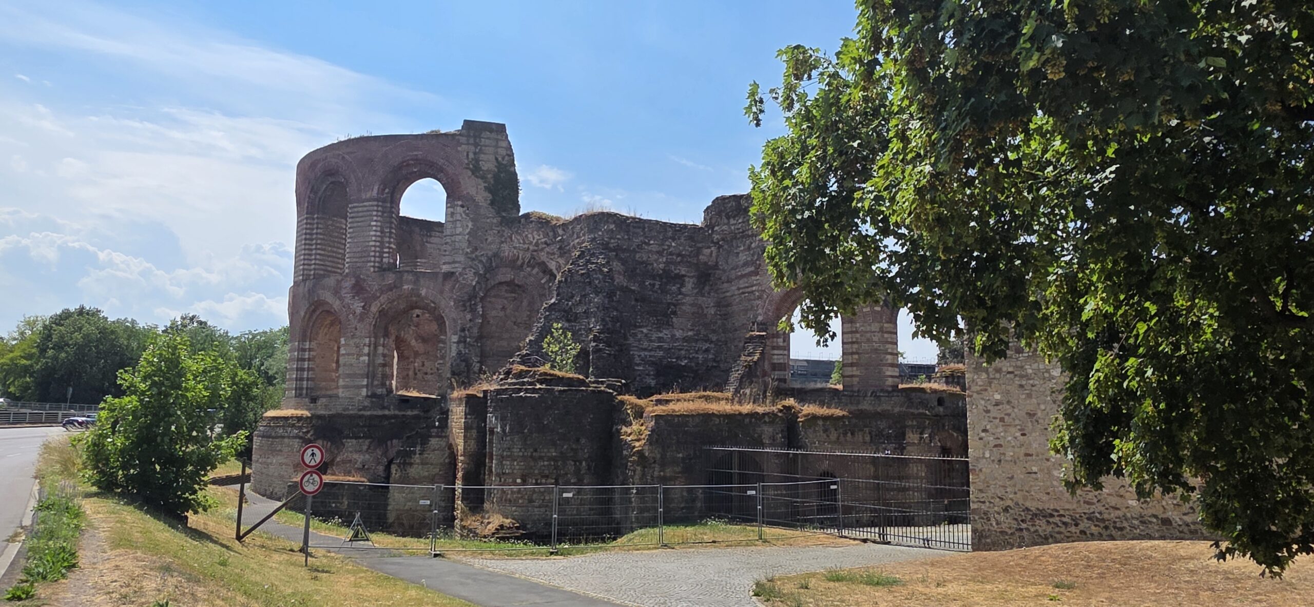 Exterior ruins of the Roman Imperial Baths in Trier, surrounded by trees